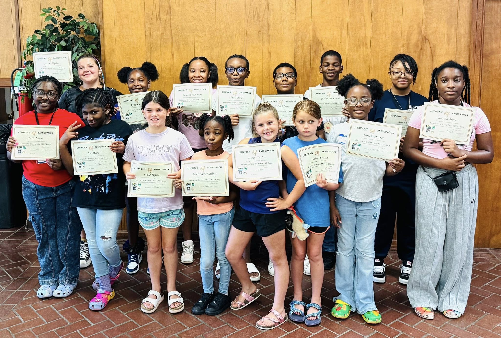 A group of kids holding certificates.